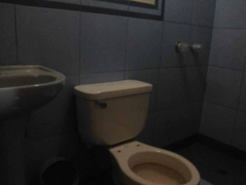 a bathroom with a toilet and a sink at Hostal Jara in Lima