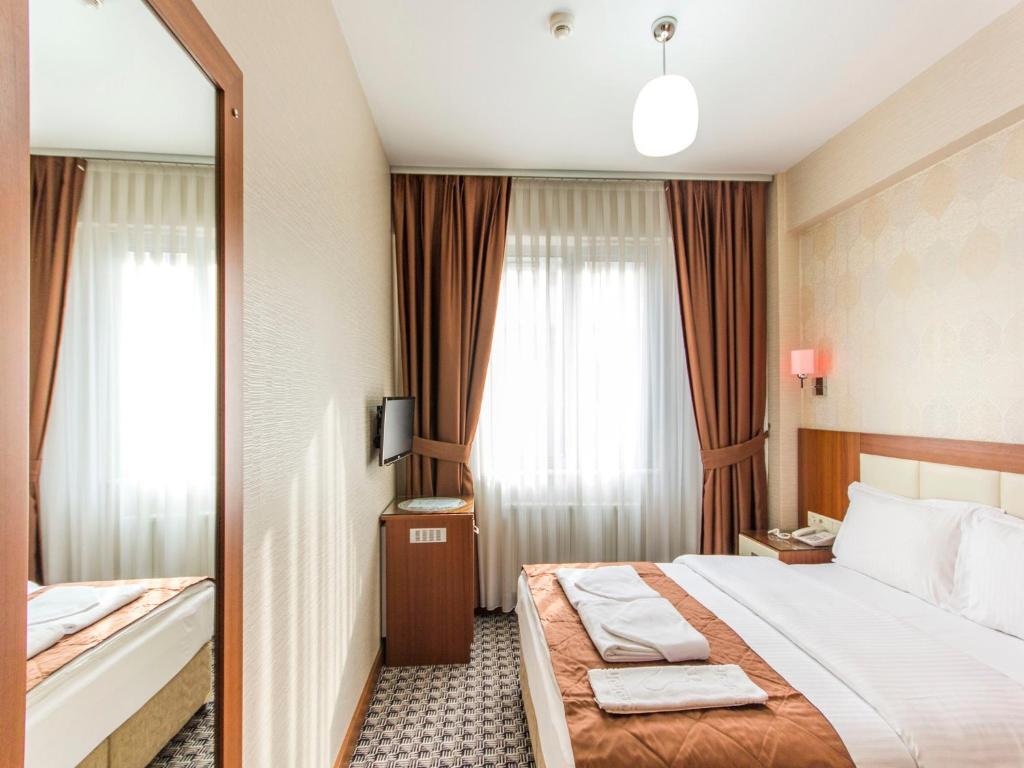 Postel nebo postele na pokoji v ubytování Mint Residence Taksim