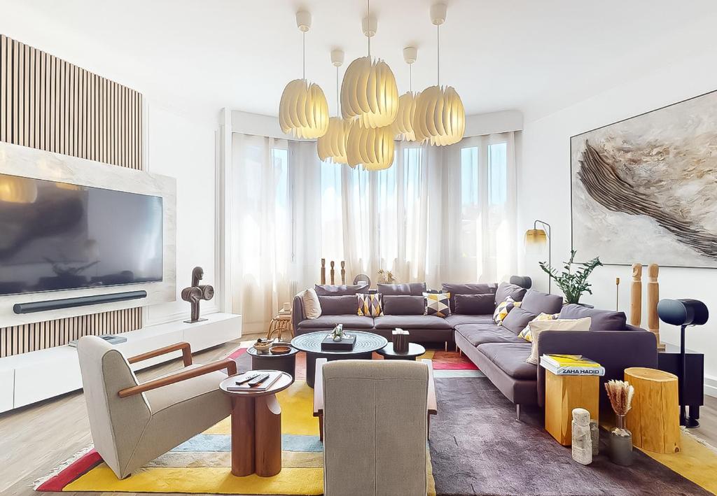 un salon avec un canapé et une télévision dans l'établissement Signature Champs Elysées, à Paris