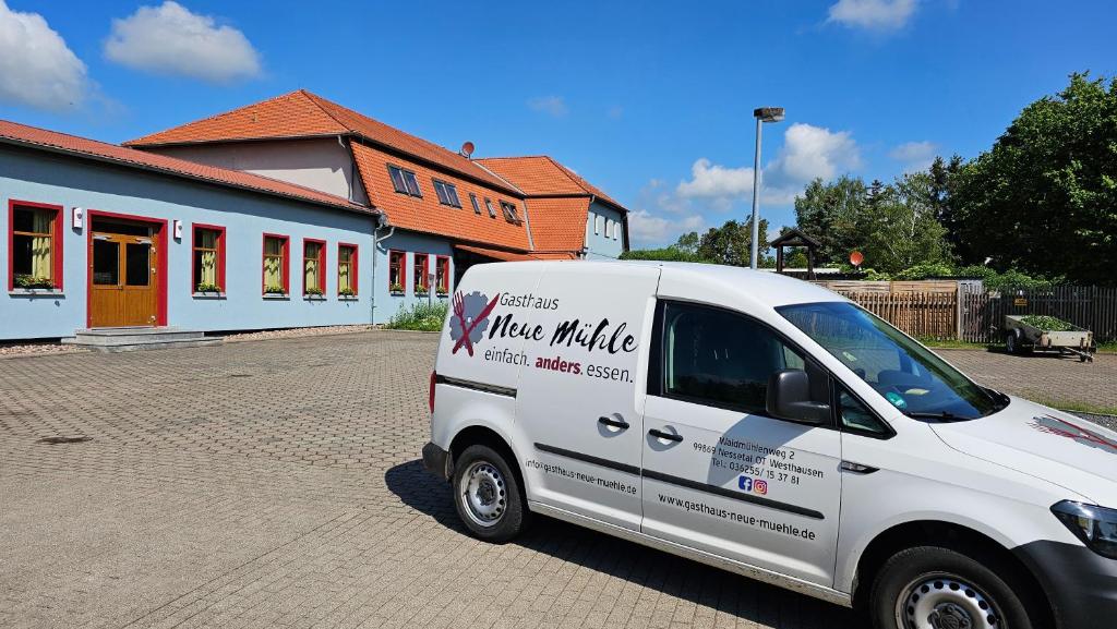 a white van parked in front of a building at Gasthaus Neue Mühle in Westhausen