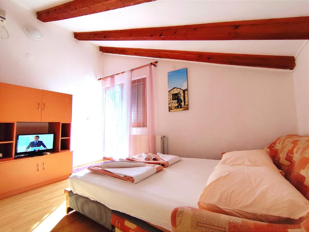 Postel nebo postele na pokoji v ubytování Apartments Bilo