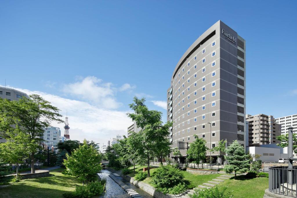 a rendering of a tall building next to a river at Fairfield by Marriott Sapporo in Sapporo