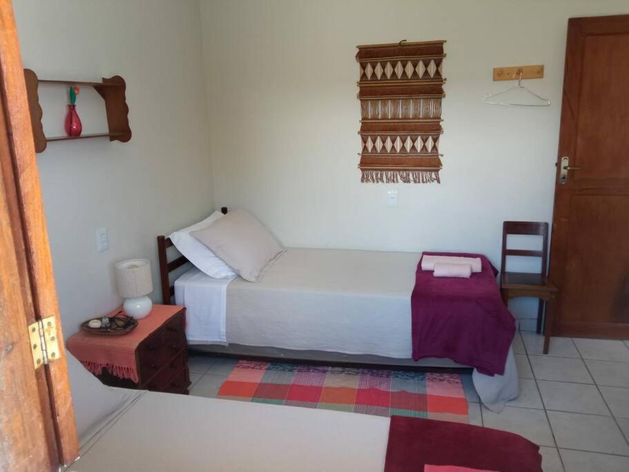 Postel nebo postele na pokoji v ubytování CASA DA PRAÇA Ibicoara - a melhor hospedagem