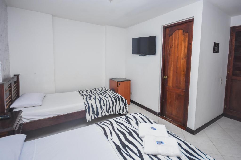 Postel nebo postele na pokoji v ubytování Hotel Estadio Real