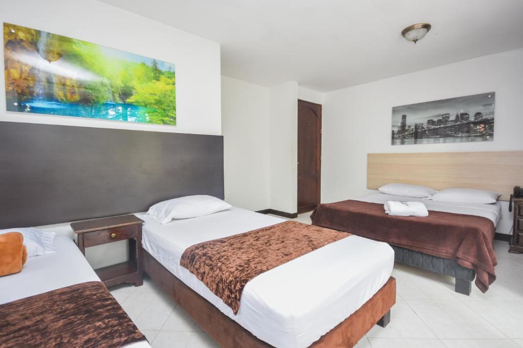 Postel nebo postele na pokoji v ubytování Hotel Estadio Real