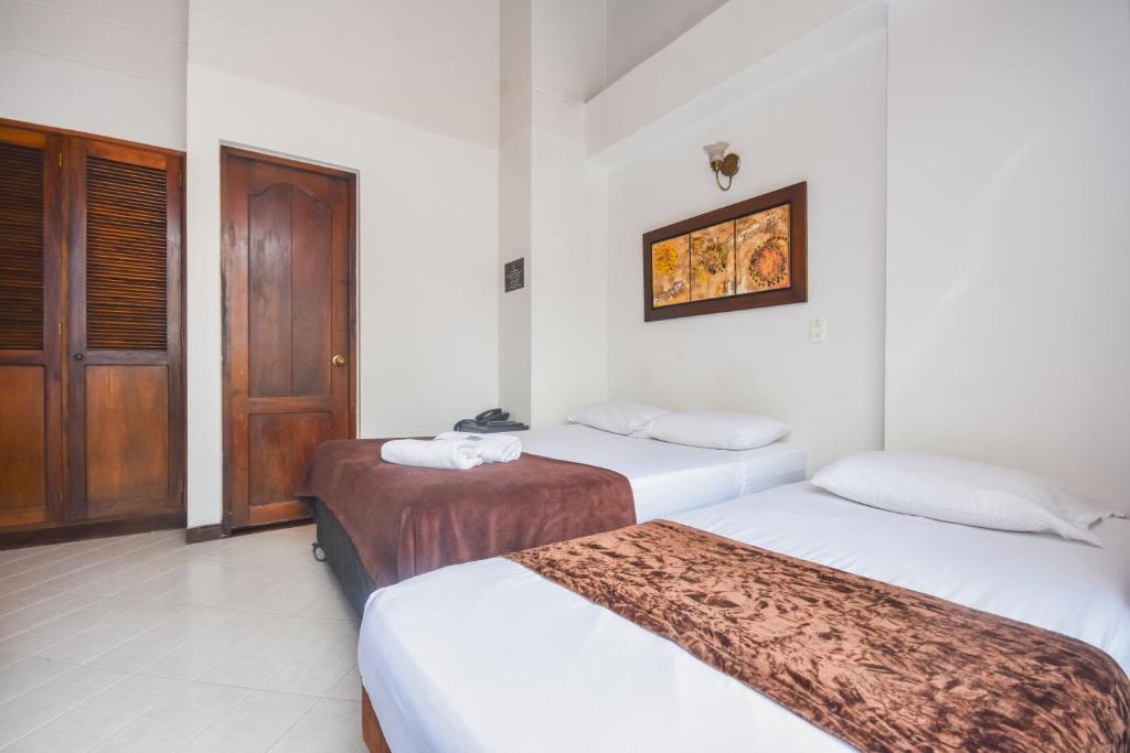 Postel nebo postele na pokoji v ubytování Hotel Estadio Real