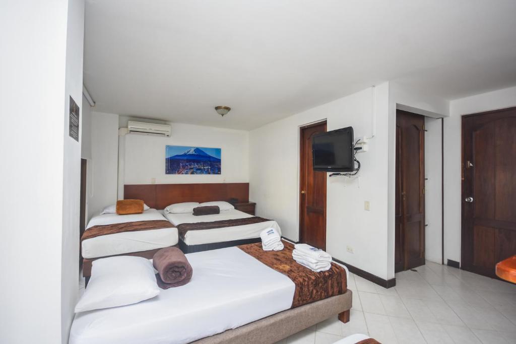 Postel nebo postele na pokoji v ubytování Hotel Estadio Real