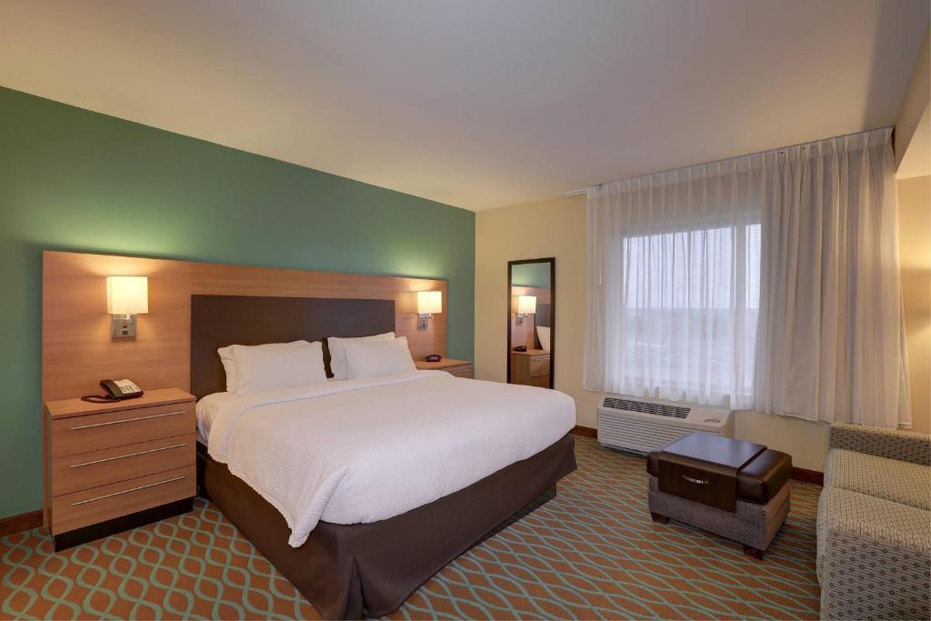 a hotel room with a large bed and a window at TownePlace Suites Richland Columbia Point in Richland