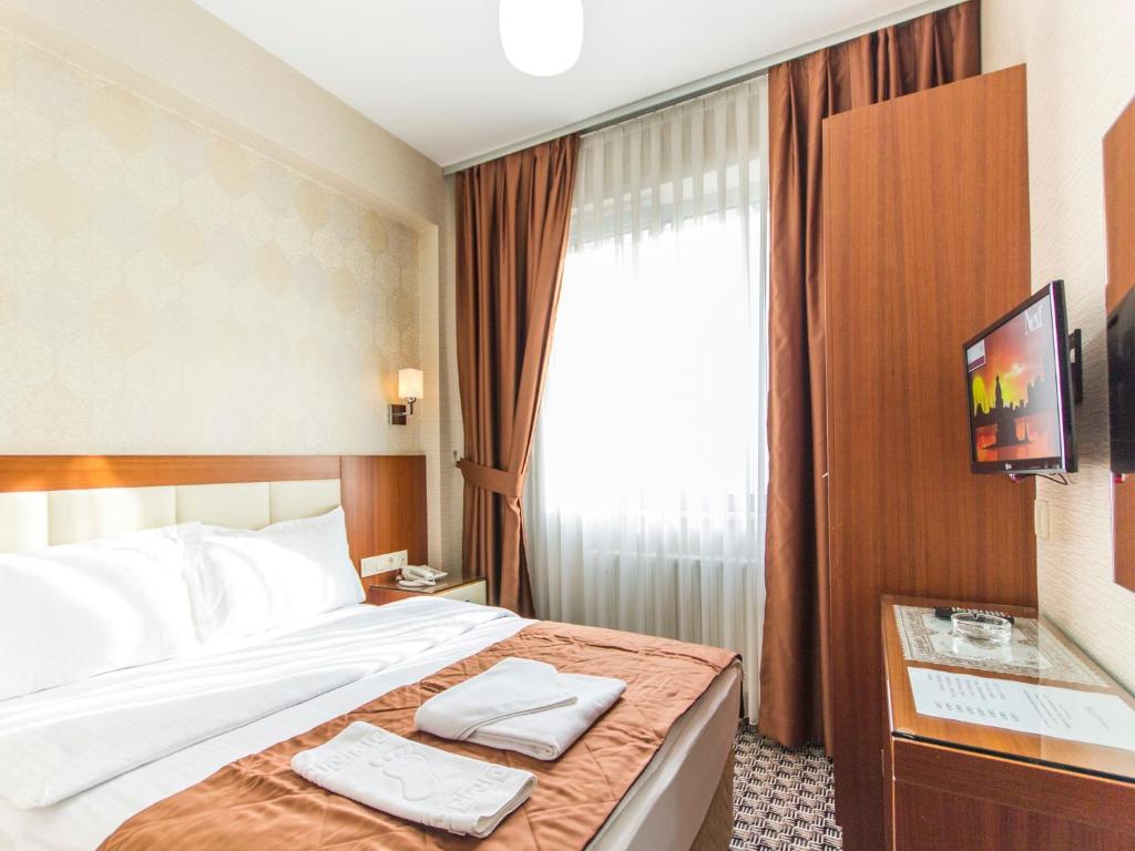 Postel nebo postele na pokoji v ubytování Mint Residence Taksim