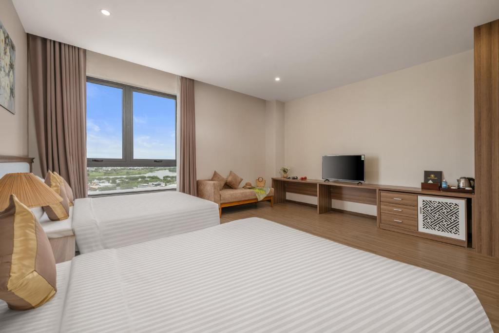 Postel nebo postele na pokoji v ubytování ATP Galaxy Hotel & Apartment Danang