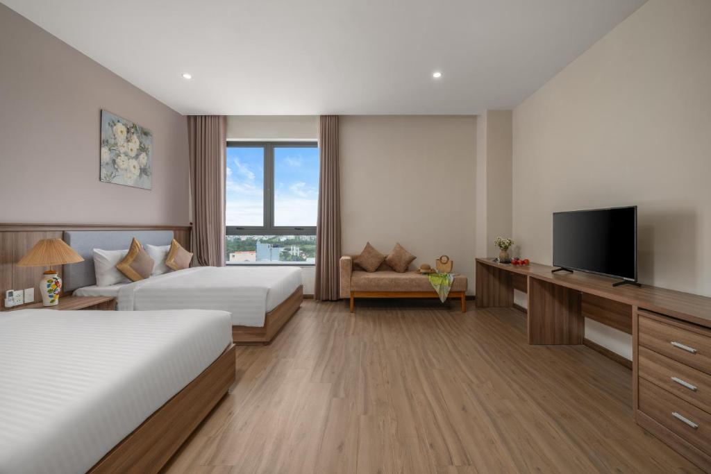 Postel nebo postele na pokoji v ubytování ATP Galaxy Hotel & Apartment Danang