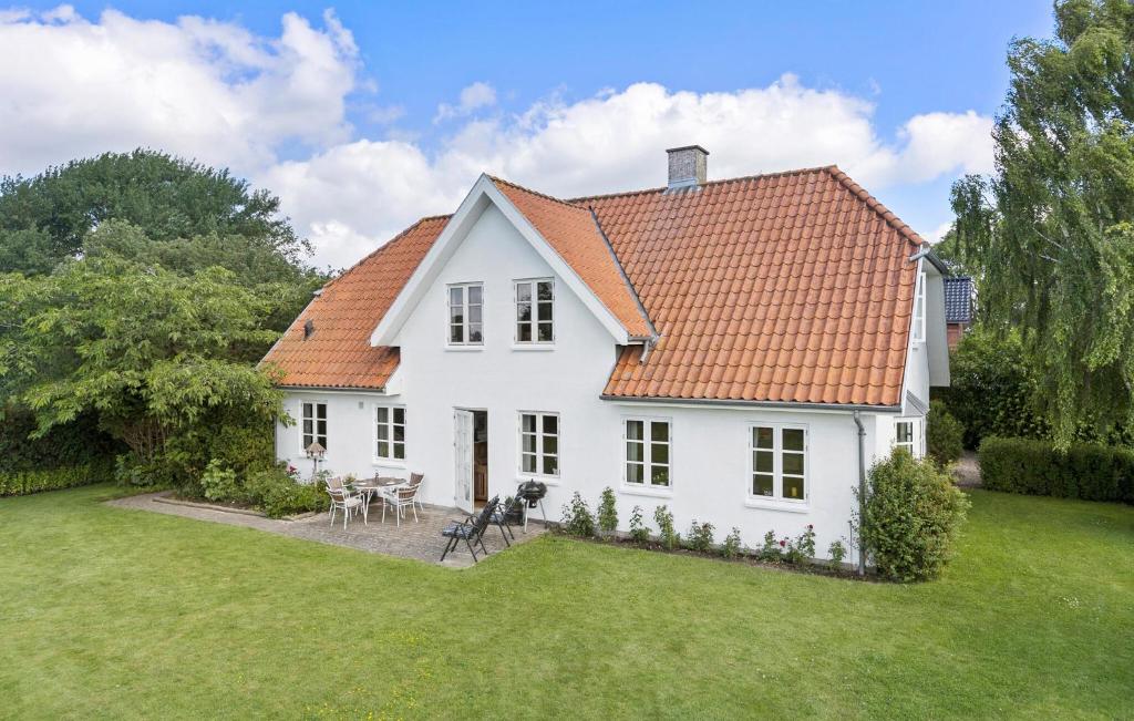 a white house with an orange roof at Nice Home In Sønderborg With Kitchen in Sønderborg