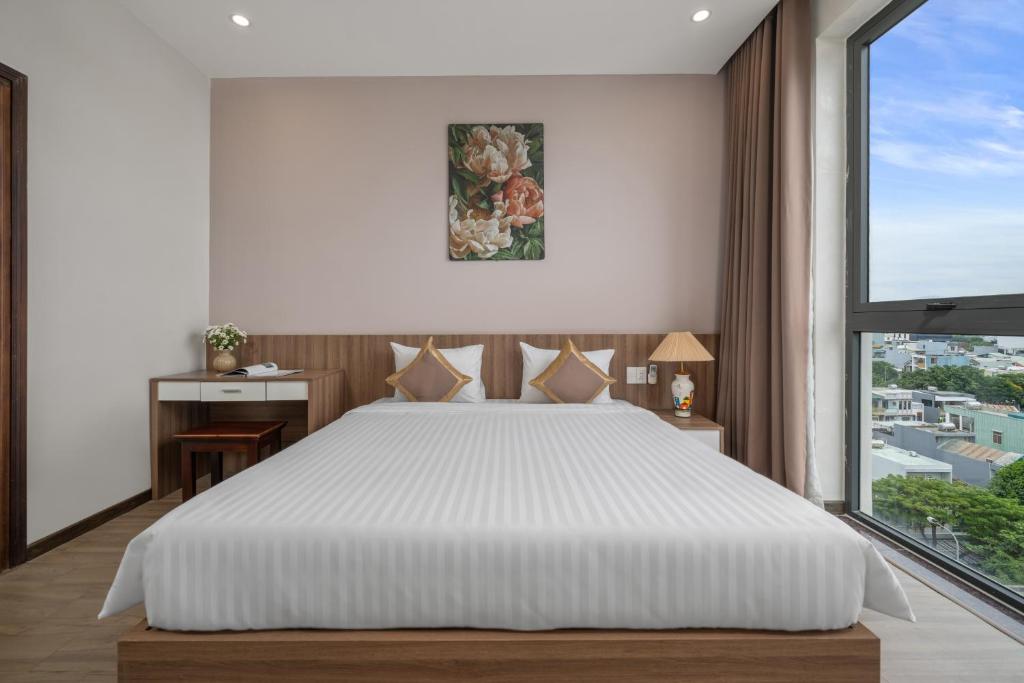 Postel nebo postele na pokoji v ubytování ATP Galaxy Hotel & Apartment Danang