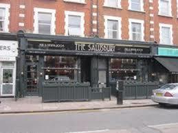 a building on a city street with a store at 118 Brondesbury Road Apartments in London