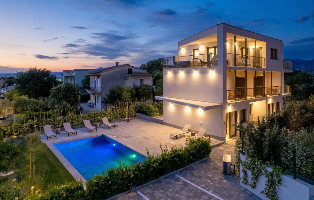 a villa with a swimming pool and a house at Gorgeous Apartment In Omisalj in Omišalj