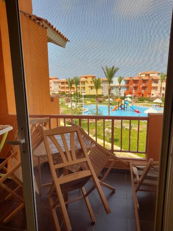 a balcony with a view of a swimming pool at Porto Matrouh Chalet شاليه بورتو مطروح in Marsa Matruh