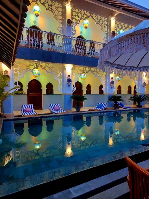 a swimming pool in a hotel with a swimming poolvisorvisor at Blue Garden Boutique Hotel in Jepara