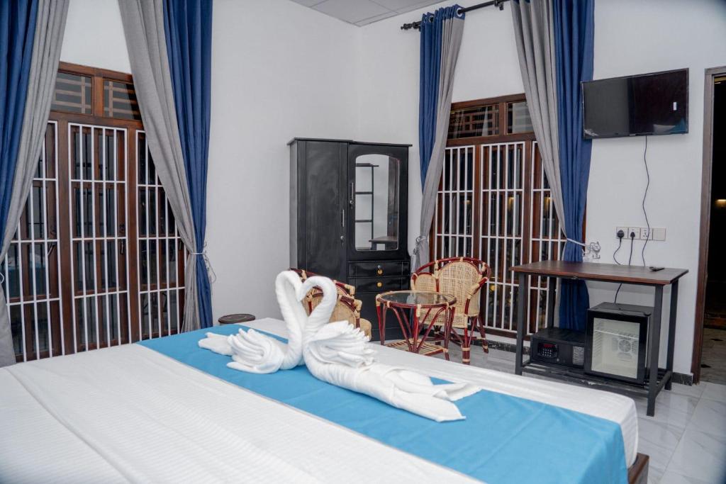 Postel nebo postele na pokoji v ubytování Aathi Resort