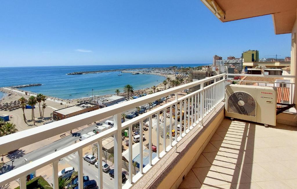 a balcony with a view of a beach and the ocean at Cozy Apartment In Fuengirola With Wifi in Fuengirola