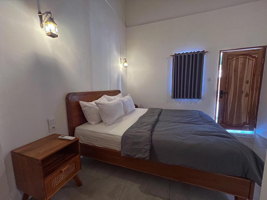Postel nebo postele na pokoji v ubytování Bae Gili Inn