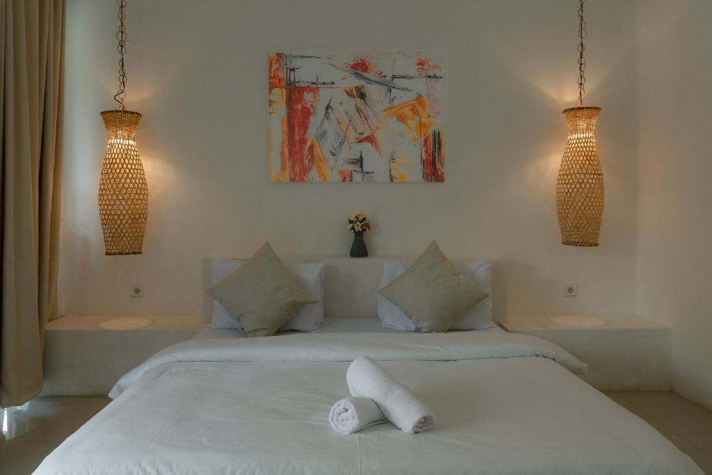Postel nebo postele na pokoji v ubytování Gili Paddy Hotel