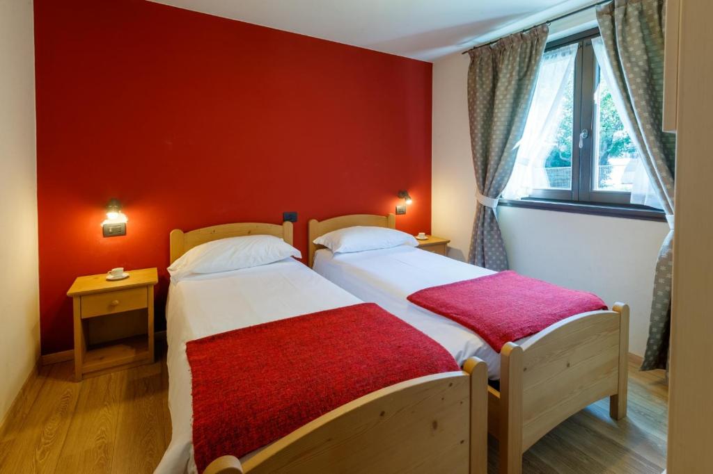 Postel nebo postele na pokoji v ubytování Chalet Silvi Residence