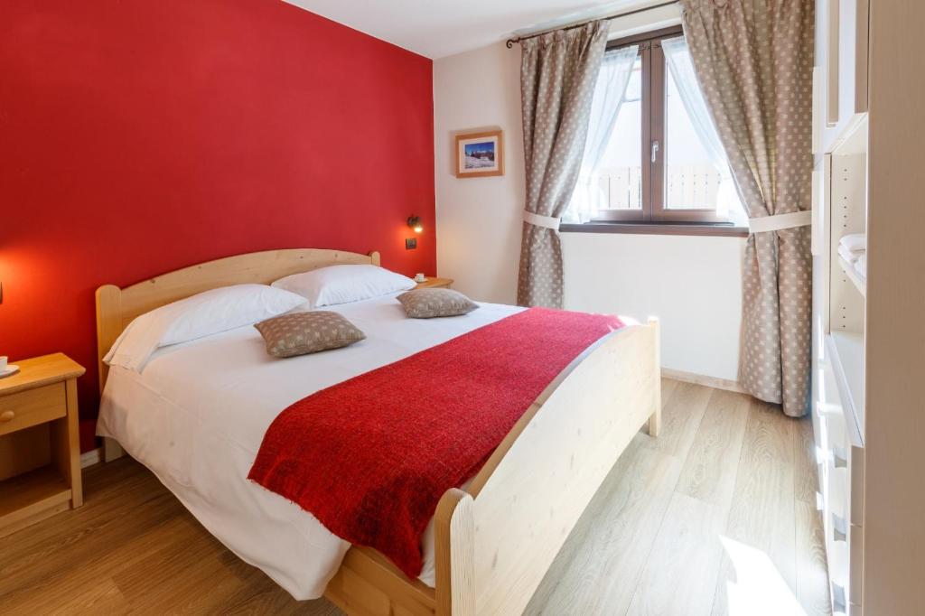 Postel nebo postele na pokoji v ubytování Chalet Silvi Residence