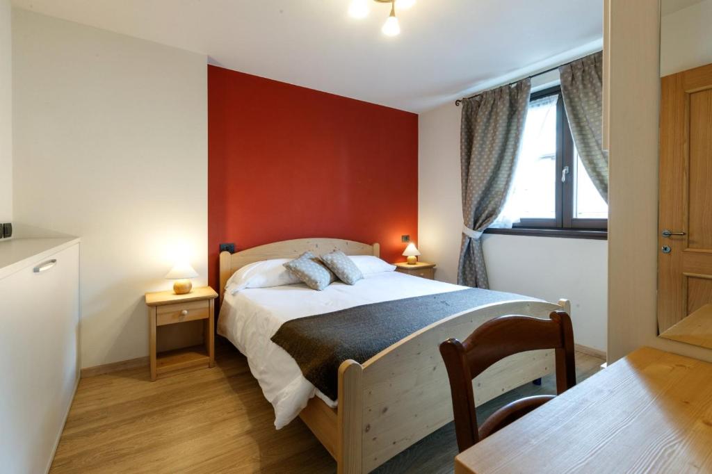 Postel nebo postele na pokoji v ubytování Chalet Silvi Residence