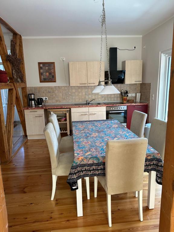 a kitchen with a dining room table and chairs at Ferienwohnung Mathilda in Waren