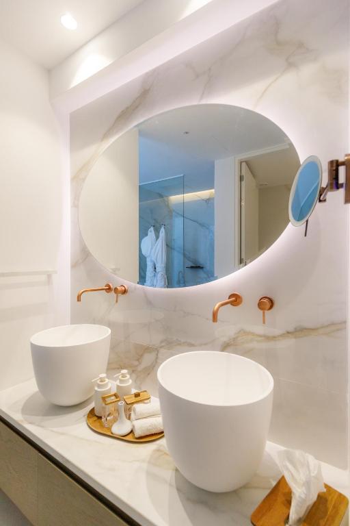 a bathroom with two sinks and a mirror at Tasia Maris Beach Hotel - Adults Only in Ayia Napa