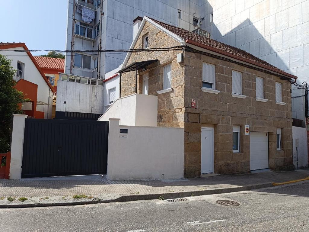 an old brick house on a street with a gate at Casa Miguel in Teis