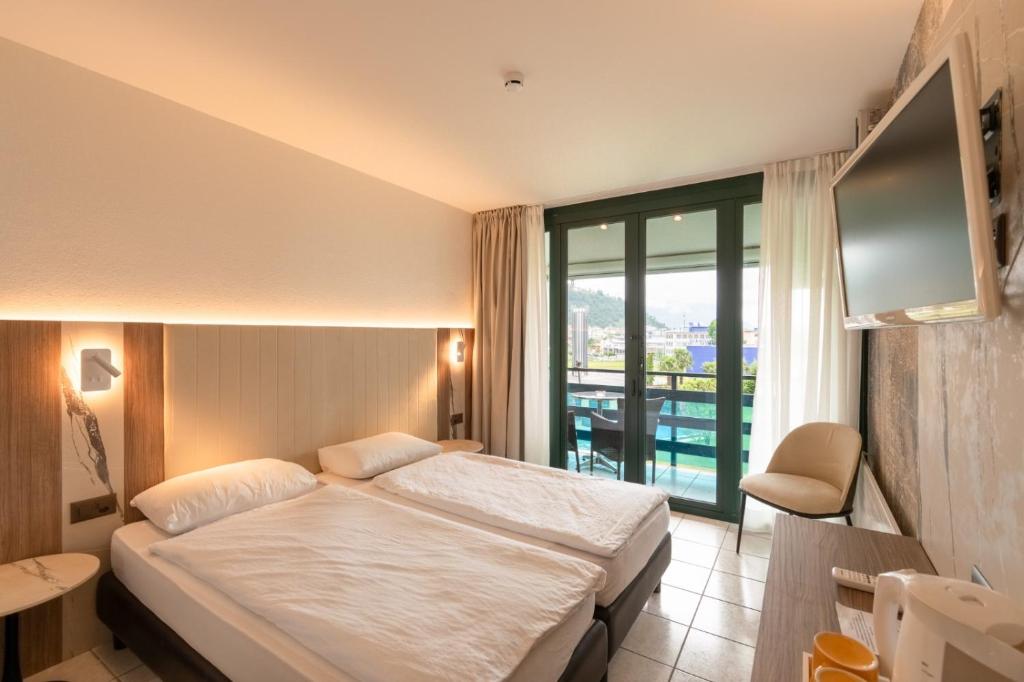 Postel nebo postele na pokoji v ubytování Hotel Tiziana