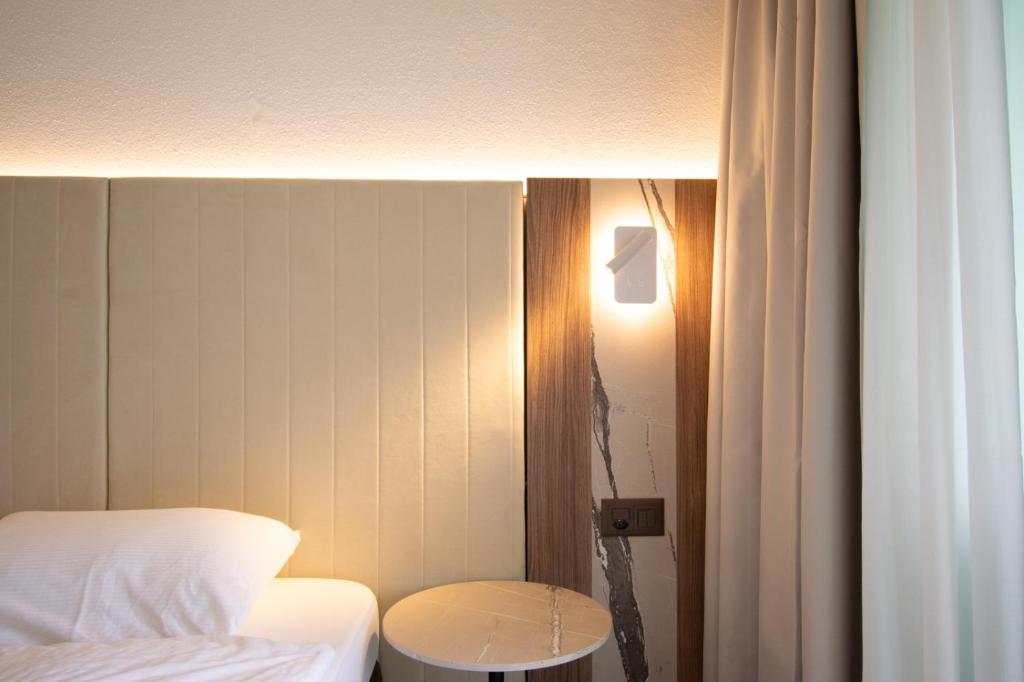 Postel nebo postele na pokoji v ubytování Hotel Tiziana