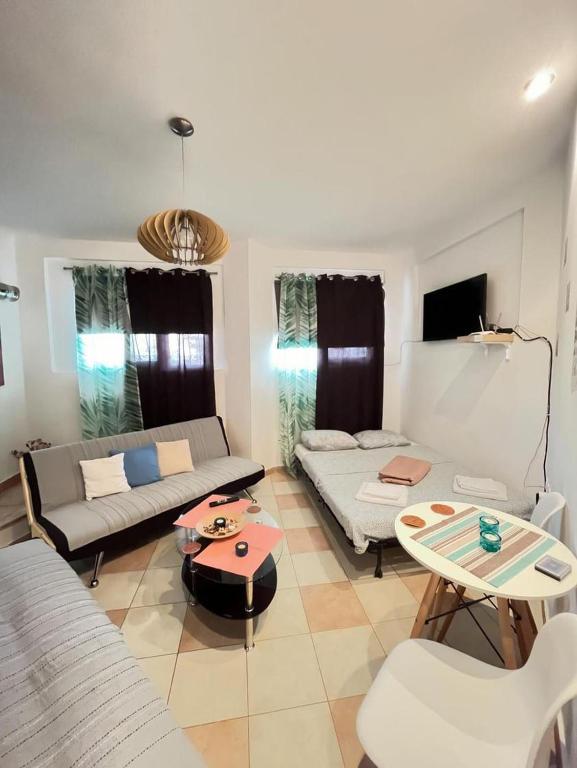 a living room with a couch and a table at Soyzana heavenly home in Néa Kerasiá
