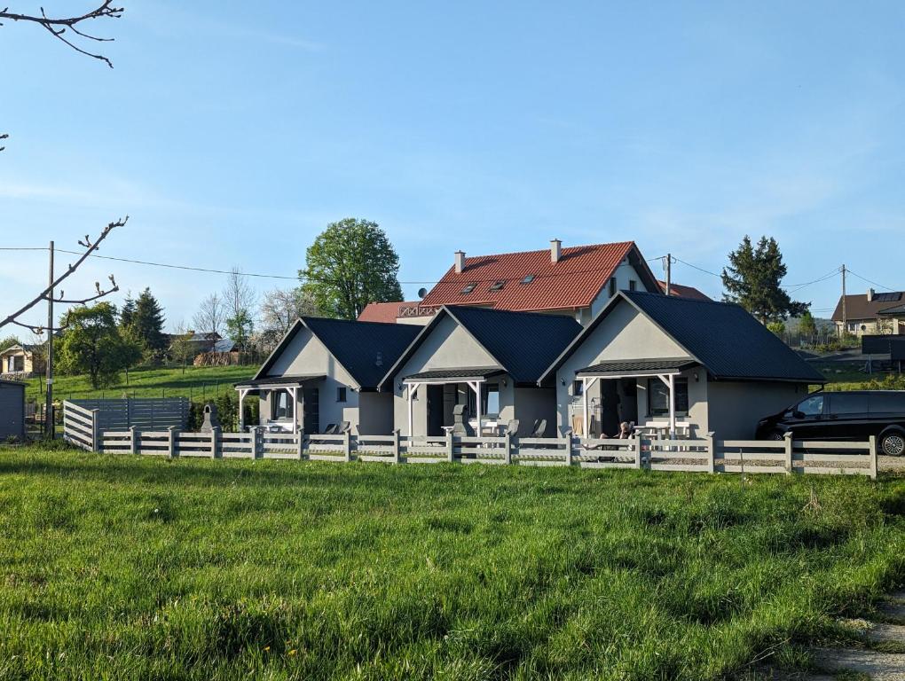 a house with a fence in front of it at BiesCzadowa Dolina in Ustrzyki Dolne