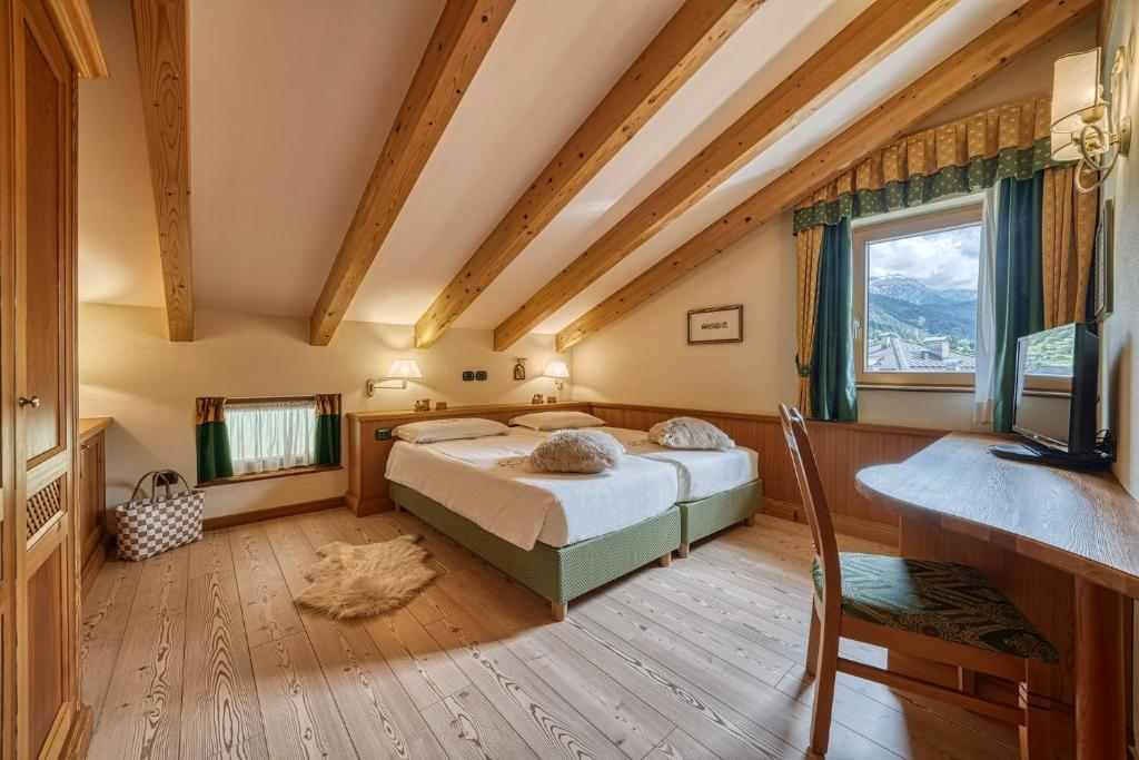 Postel nebo postele na pokoji v ubytování Brunet - The Dolomites Resort