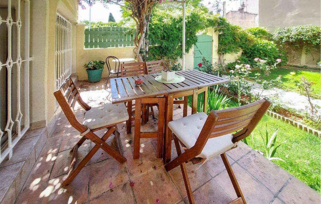 a wooden table and chairs on a patio at 1 Bedroom Cozy Apartment In Toulon in Toulon