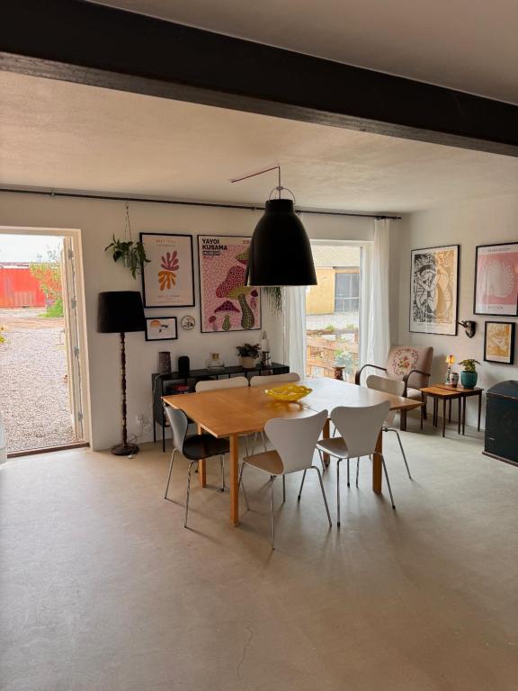 a living room with a dining room table and chairs at Amazing holiday apartment - Clara in Ebeltoft