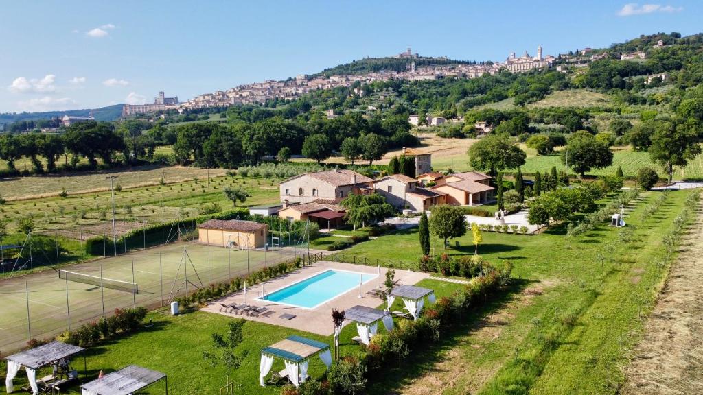 an aerial view of a villa with a tennis court at Giotto Country House & Spa in Assisi