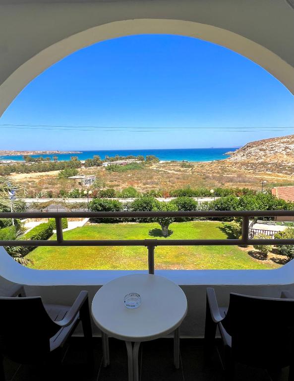 a window with a table and a view of the ocean at Karteros Hotel in Karteros