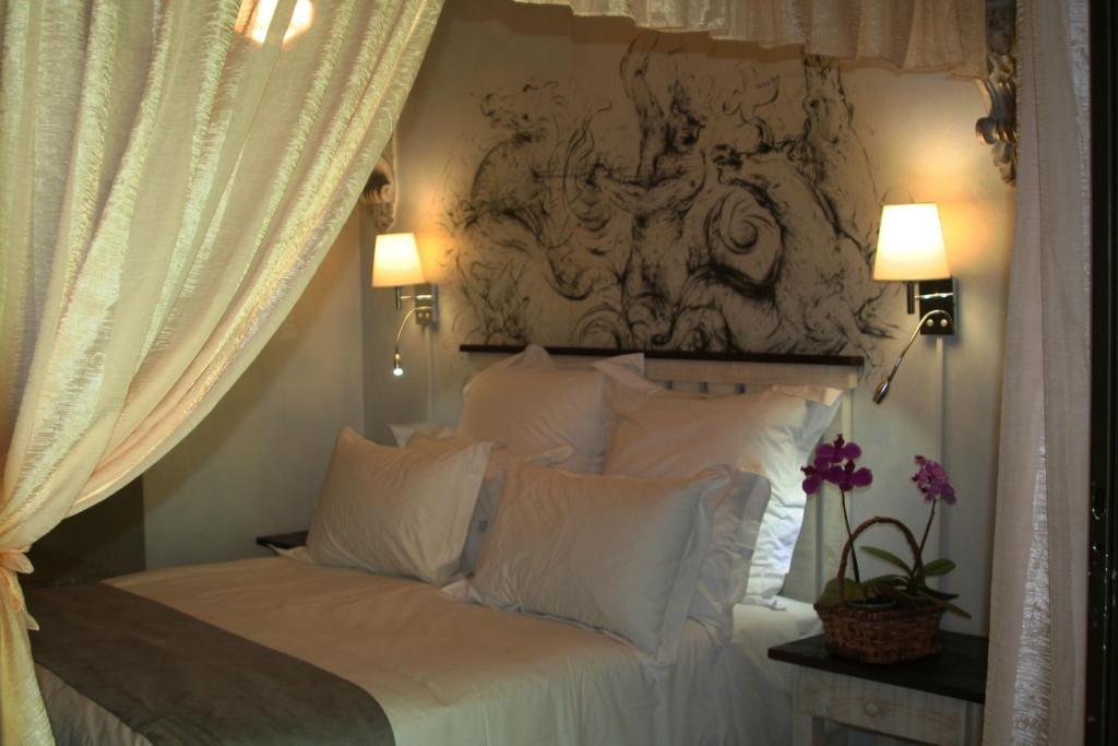 a bedroom with a large bed with white pillows at Stephward Estate Country House in Uvongo Beach