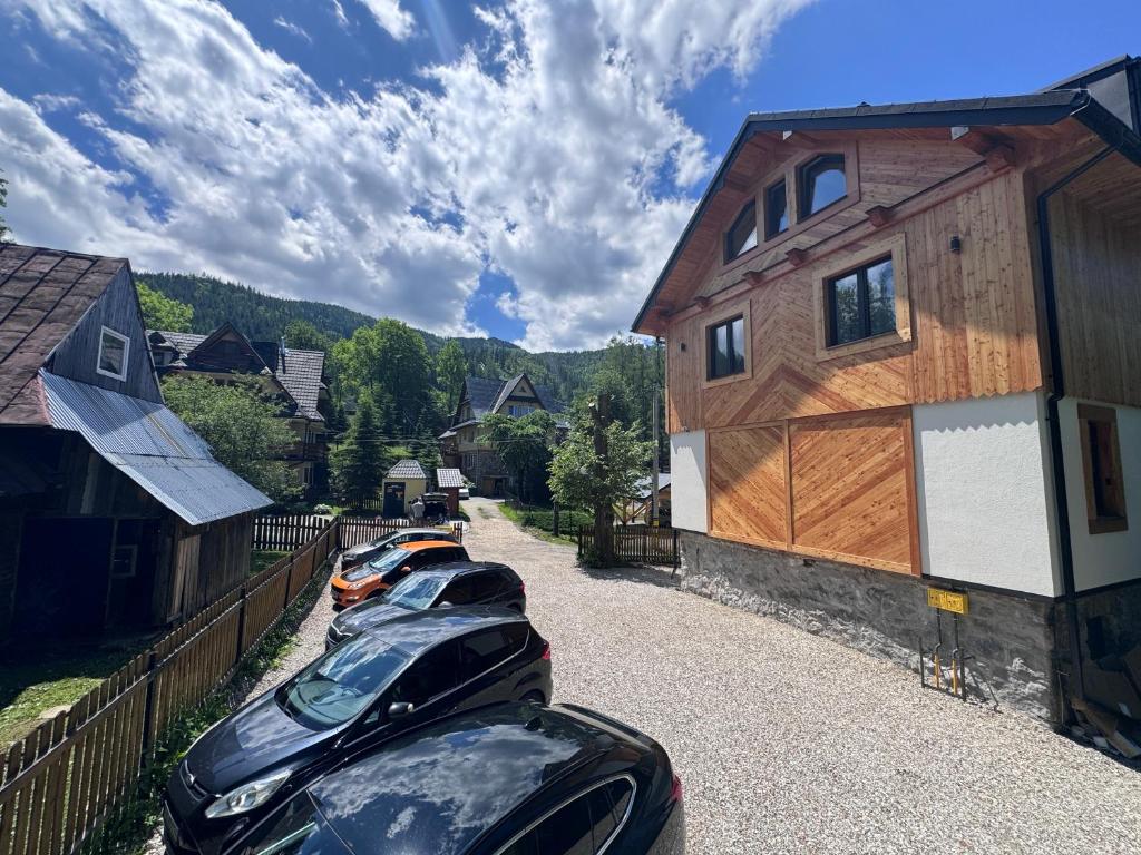 a row of parked cars parked next to a building at Studio dla 2 osób Tatra-Dream in Zakopane