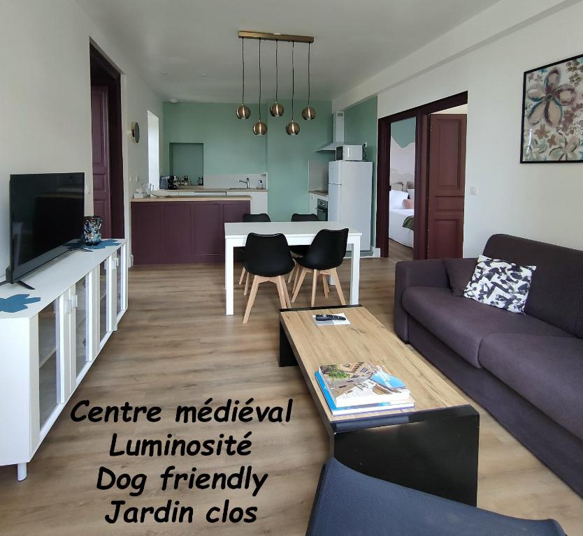 a living room with a couch and a table at Les Epingliers - Le Clos Lacam, centre ville, dog friendly in Gourdon-en-quercy