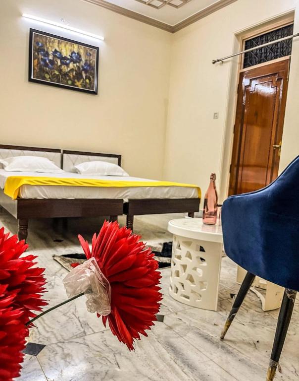 a room with a bed and a chair and a table at Serene Stays at Varanasi - 2BHK Luxury Villa in Varanasi