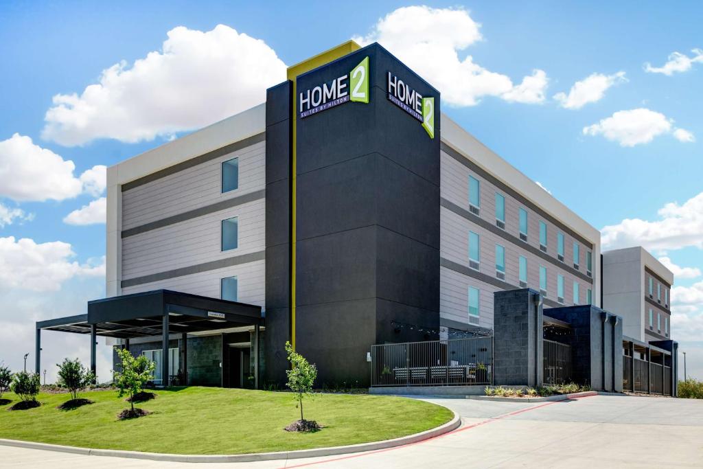 a building with a sign that reads home depot at Home2 Suites By Hilton Huntsville, Tx in Huntsville