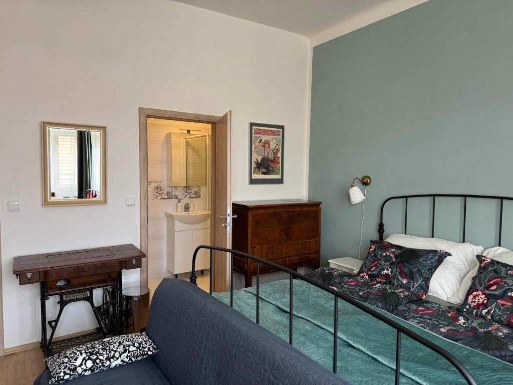 a living room with a bed and a couch at Apartments Bouquet in Prague