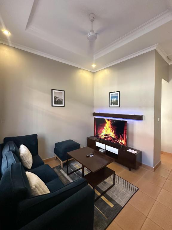 a living room with a couch and a fireplace at Actionpack Travels in Dar es Salaam