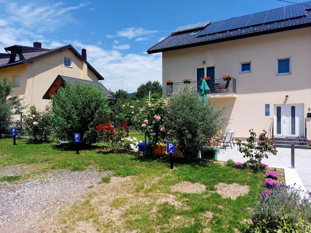 a house with a garden in front of it at Katarica in Korenica