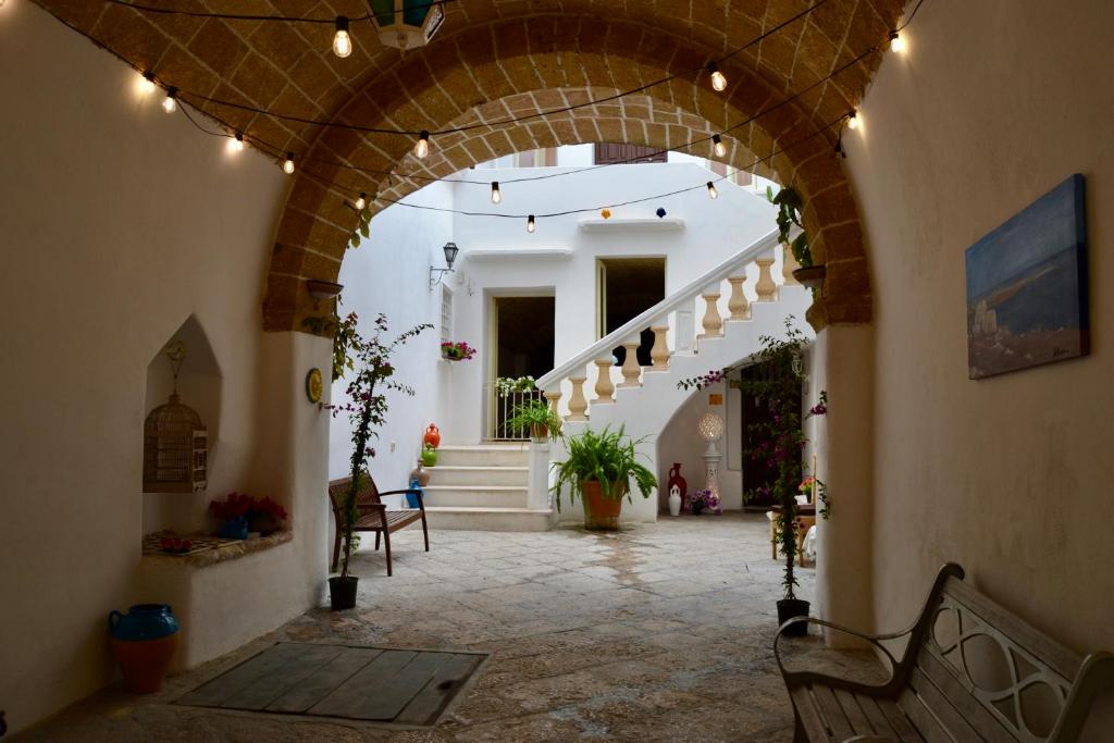 an arched hallway with an archway in a building at Kàllistos Suites & Apartments in Gallipoli