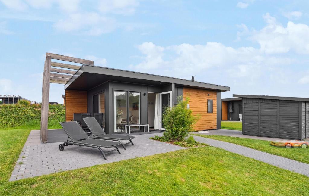 a small house with a patio and two chairs at Chalet Luv in Süsel
